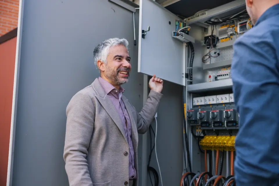 Mohamed Ezzo in front of an compact secondary substation (CSS)